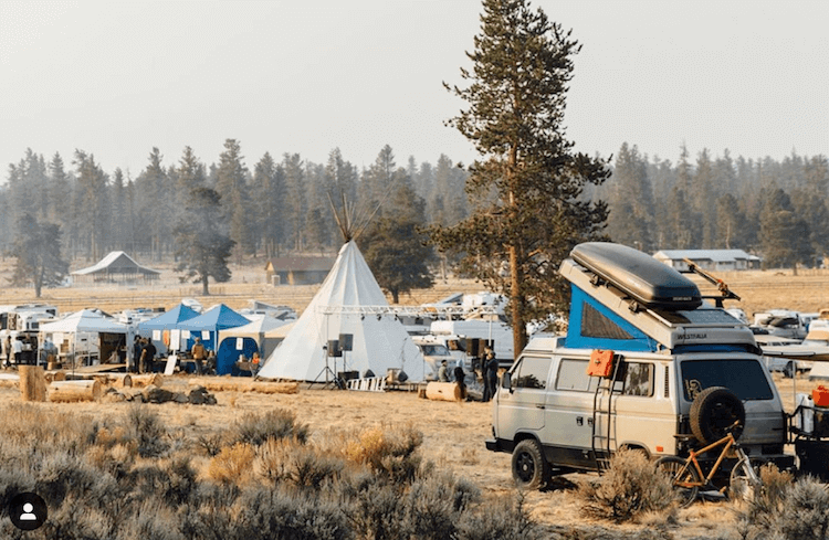 Van lifers and overlander at descend on bend, Van with rooftop camper at festival with big tent and stage|Van lifers and overlander at descend on bend, group of people singing by campfire|Van lifers and overlander at descend on bend, man on bike jumping